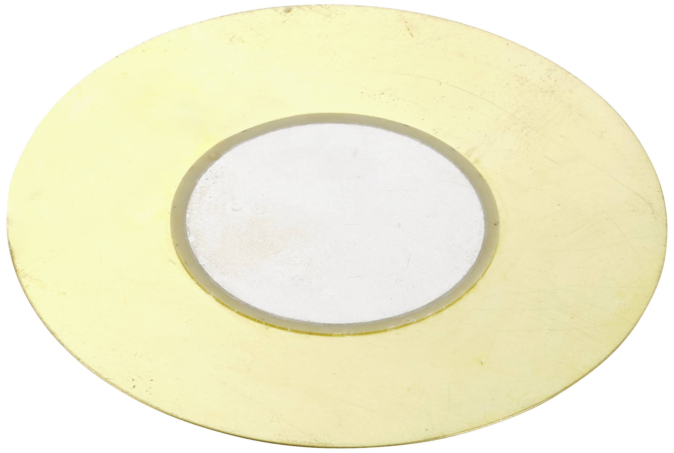 Une plaque dorée ronde avec un petit cercle blanc au centre.