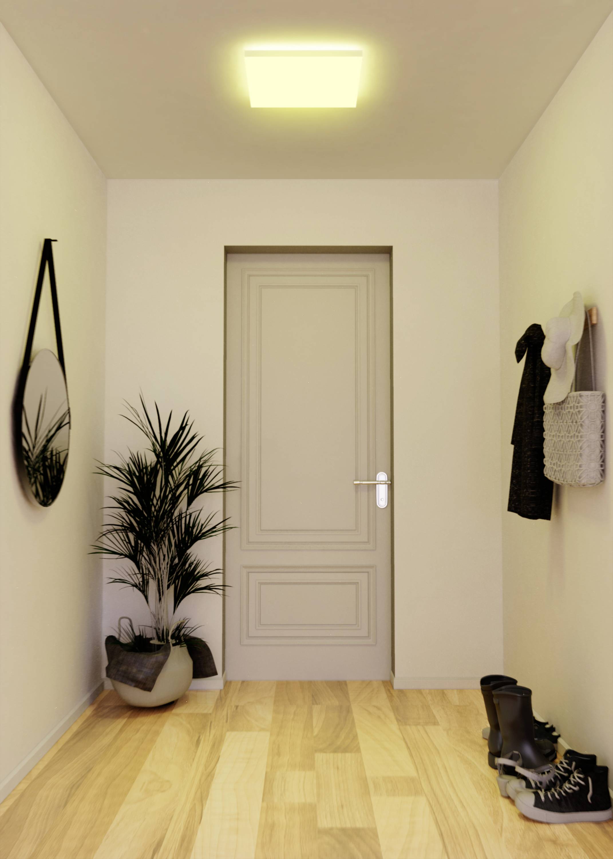 Un couloir étroit au plancher en bois mène à une porte fermée. À gauche, un miroir rond est accroché, à droite sont disposés des chaussures et des manteaux.