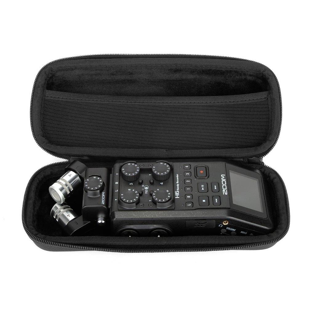 Un enregistreur audio compact avec capsules microphone et commandes dans un étui de protection ouvert.