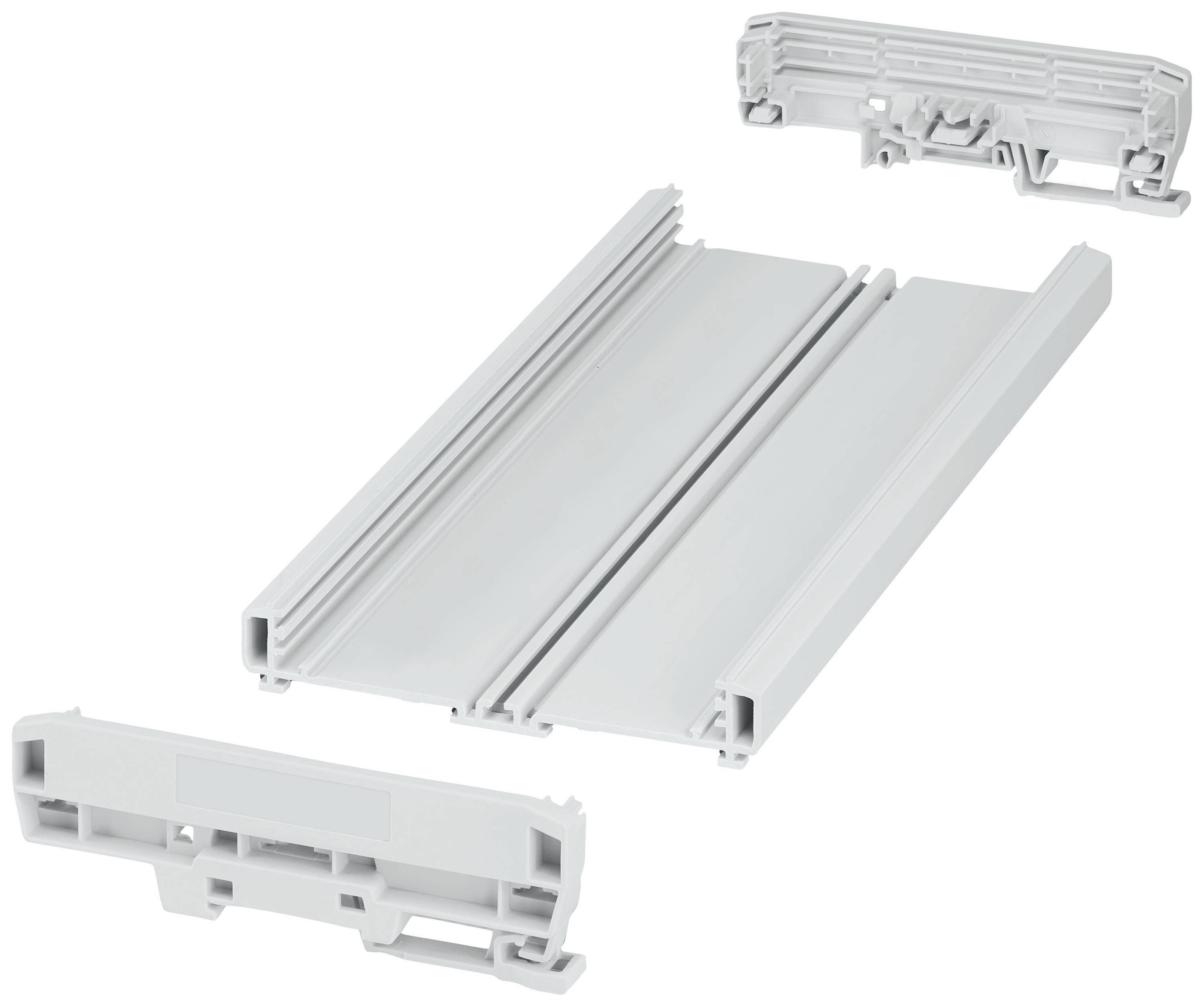 Sur l'image, on voit une pièce en plastique démontée en trois parties. Ces pièces semblent faire partie d'un système de connexion.