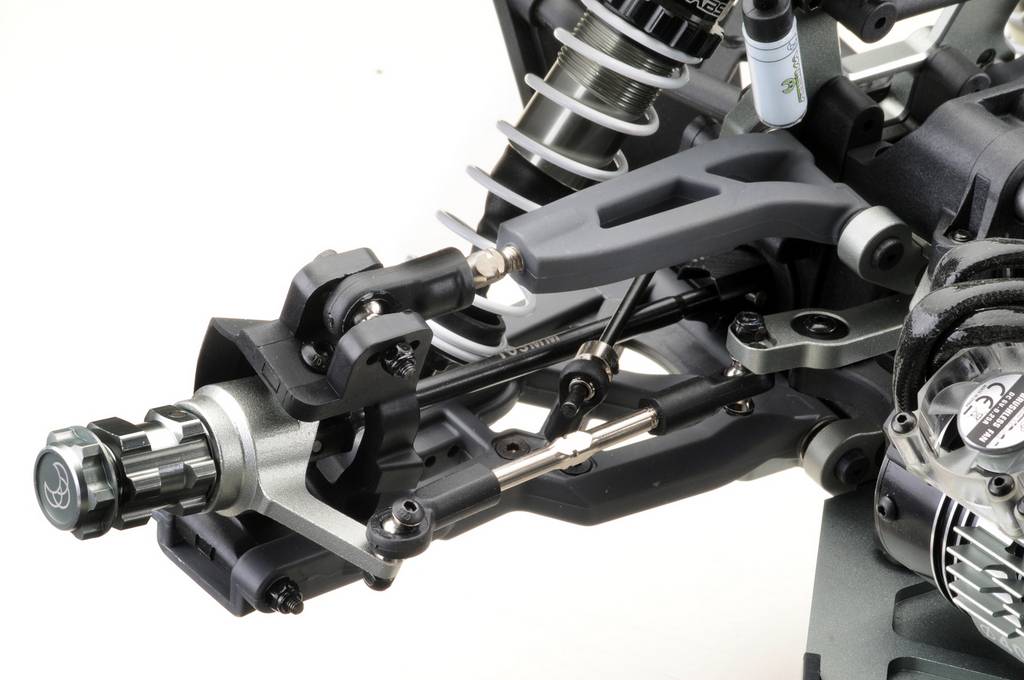 Gros plan sur le châssis d'une voiture miniature avec suspension et porte-roues visibles. Représentation détaillée des composants et des matériaux.