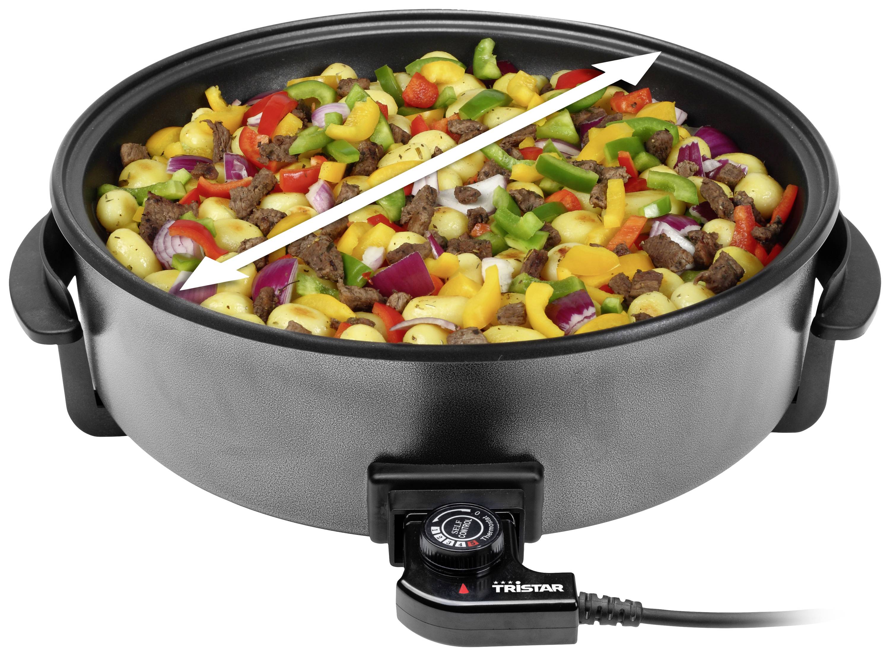 Poêle électrique noire avec des légumes colorés et de la viande, des flèches indiquant le diamètre, régulateur de température avec câble en bas.