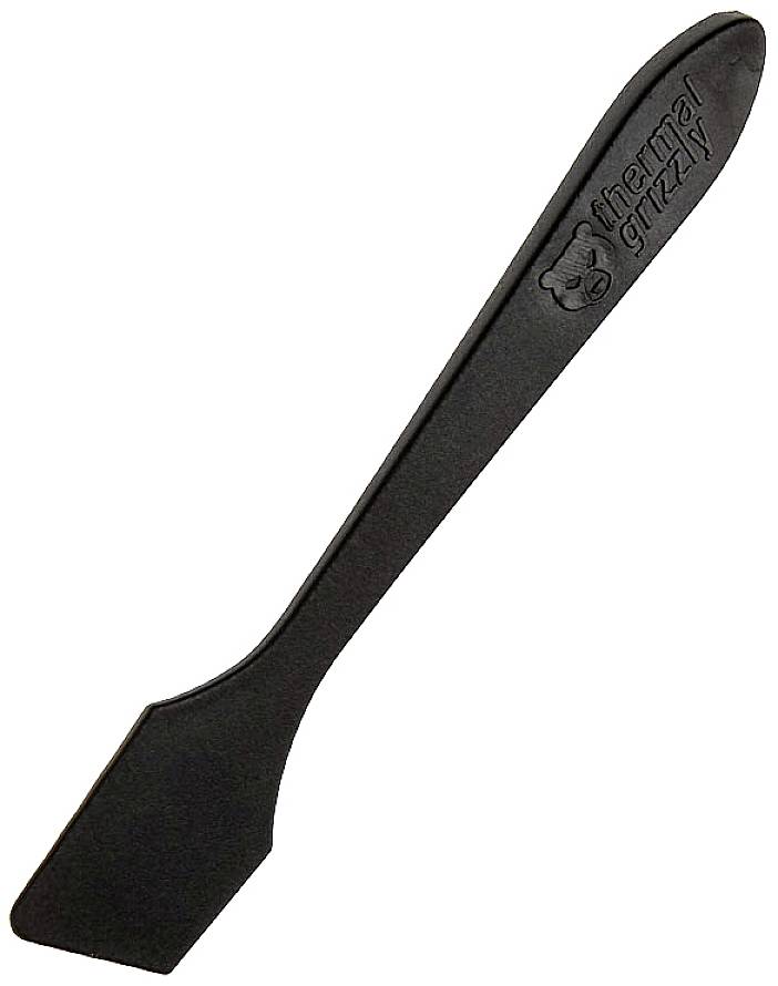 Spatule noire portant l'inscription 'thermal grizzly', utilisée pour appliquer de la pâte thermique sur des composants informatiques.