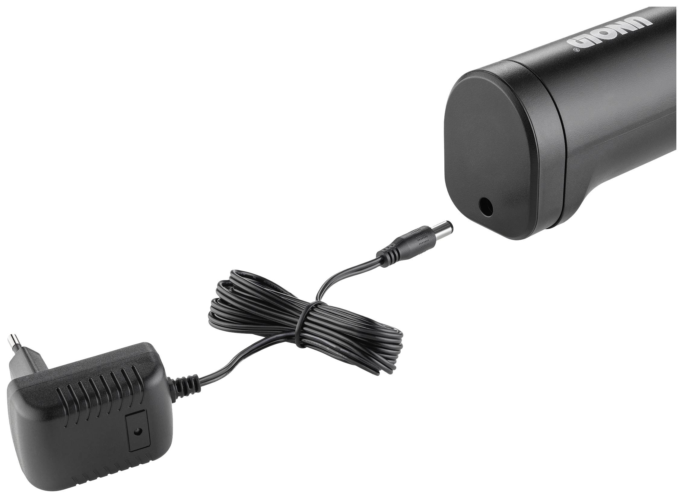 Un adaptateur secteur avec câble, connecté à un appareil cylindrique.