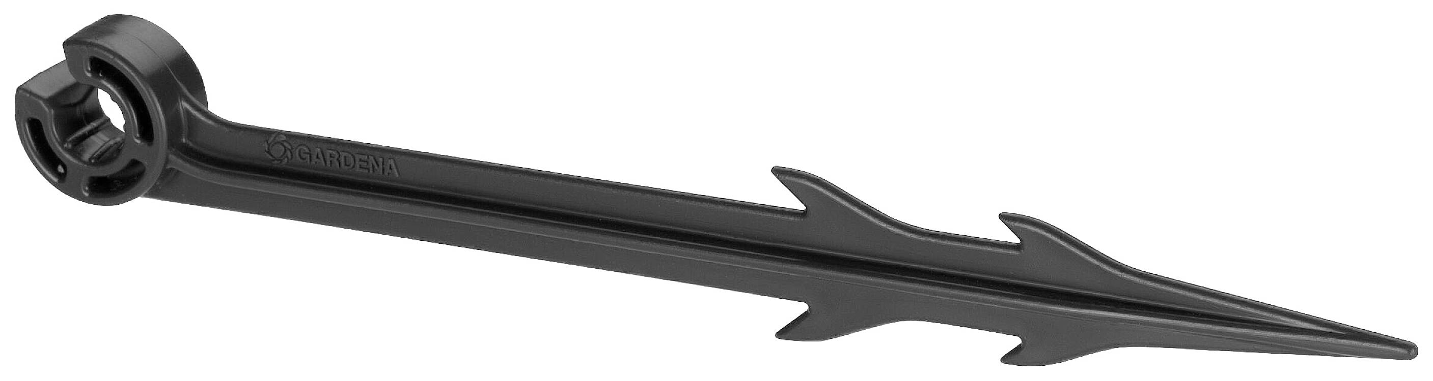 Un ancrage de sol en plastique noir avec des ailettes dentelées sert à fixer des objets dans le sol.