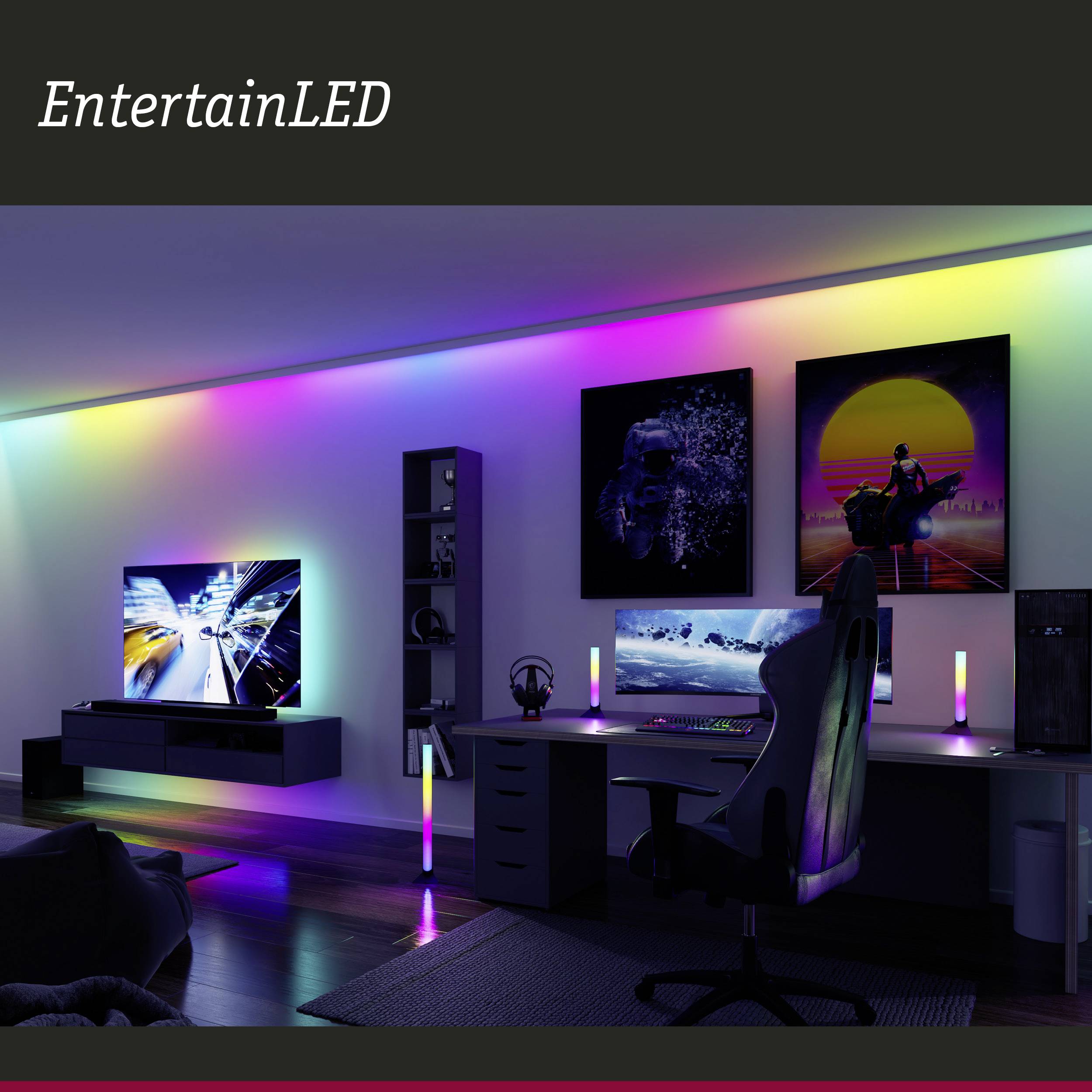 Espace moderne aménagé avec un éclairage LED aux couleurs arc-en-ciel, deux écrans sur un bureau et une ambiance futuriste.