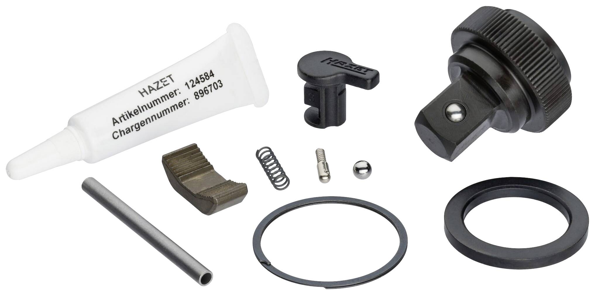 Petites pièces d'un kit de réparation : roue dentée, ressorts, bagues et un tube de lubrifiant portant l'inscription « Numéro d'article Hazet : 123584 ».