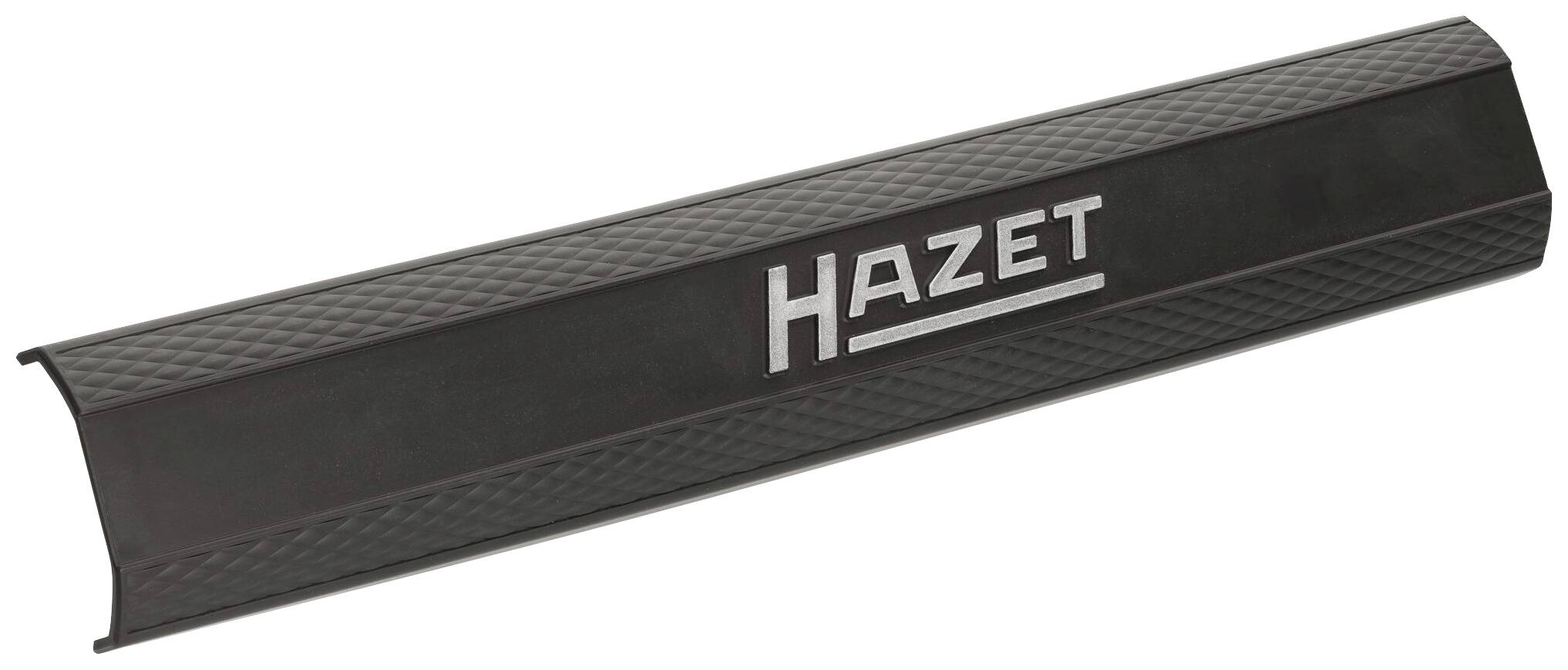 Couvercle en plastique noir portant l'inscription 'HAZET', légèrement présenté en diagonale. Logo de la marque d'outils sans contexte supplémentaire.