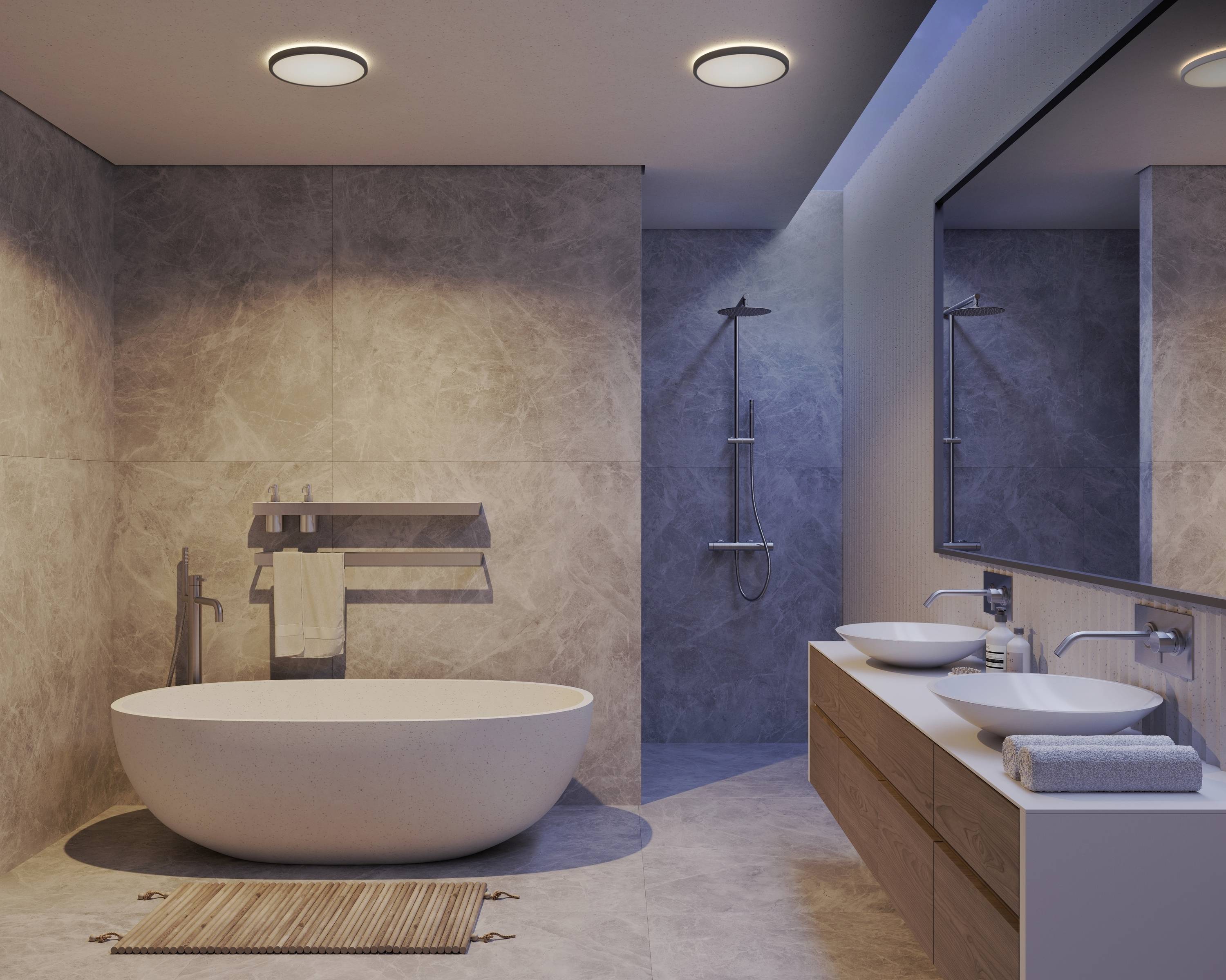 Salle de bain moderne avec baignoire îlot, deux lavabos sur un meuble sous-vasque en bois, grand miroir et douche dans des tons apaisants.
