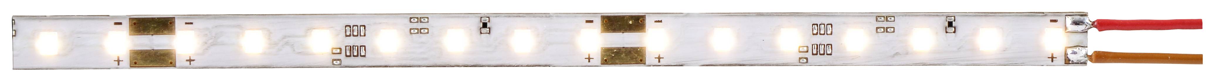 Gros plan sur une bande lumineuse à LED, montrant une rangée de LED carrées avec des connexions en cuivre sur leurs côtés.