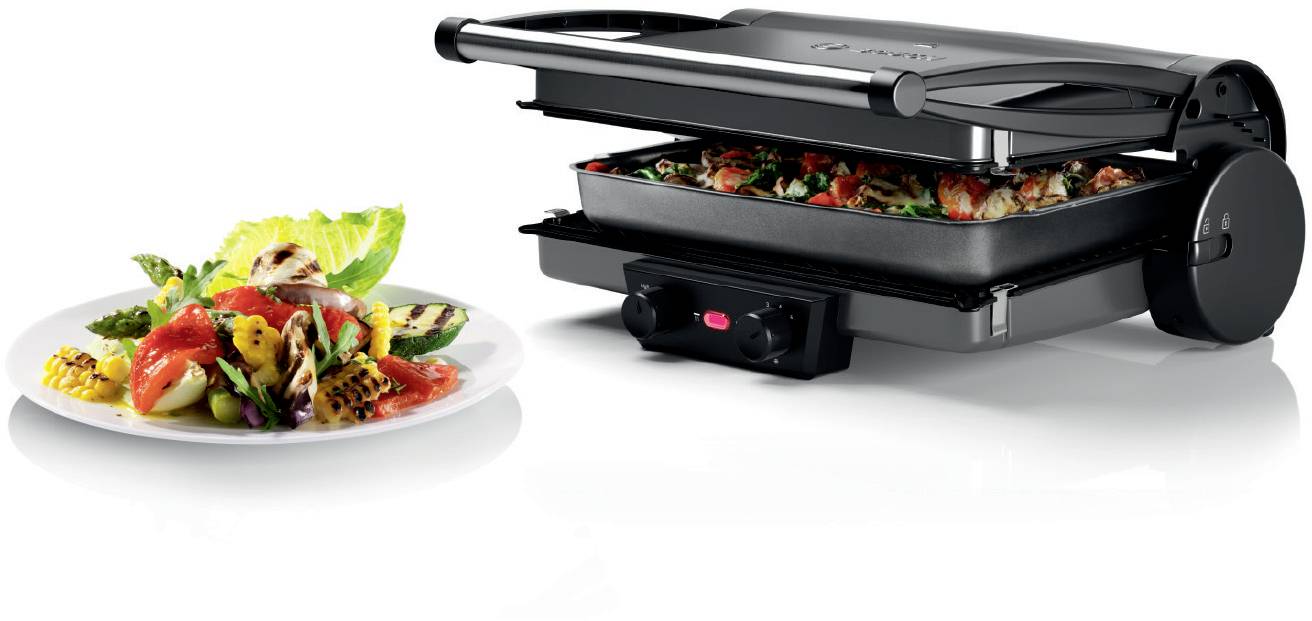 Un grill de table avec une plaque de grill ouverte. À côté, une assiette avec des légumes grillés et une salade. Idéal pour préparer des repas sains.