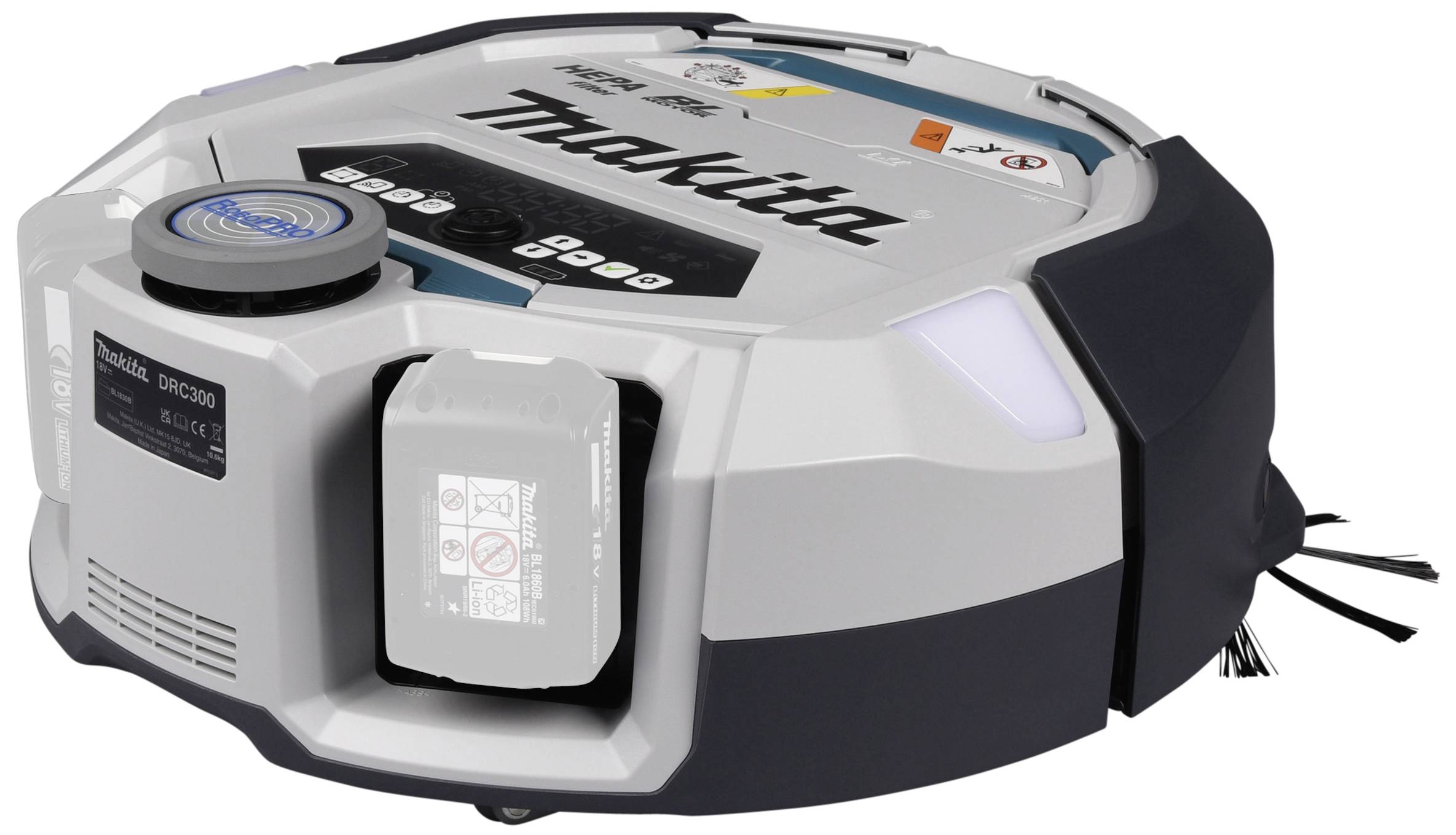 Un aspirateur robot argenté, rond, portant l'inscription 'Makita', montre ses brosses latérales et un compartiment de batterie sur sa surface supérieure.