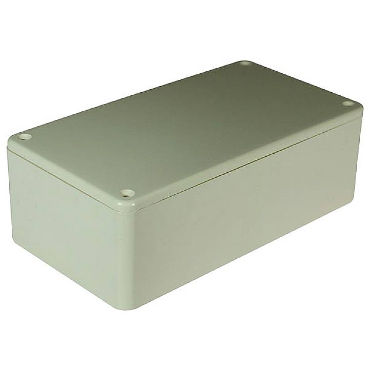 Un boîtier rectangulaire gris aux coins arrondis. Des vis sont fixées à chaque coin pour sécuriser le couvercle.