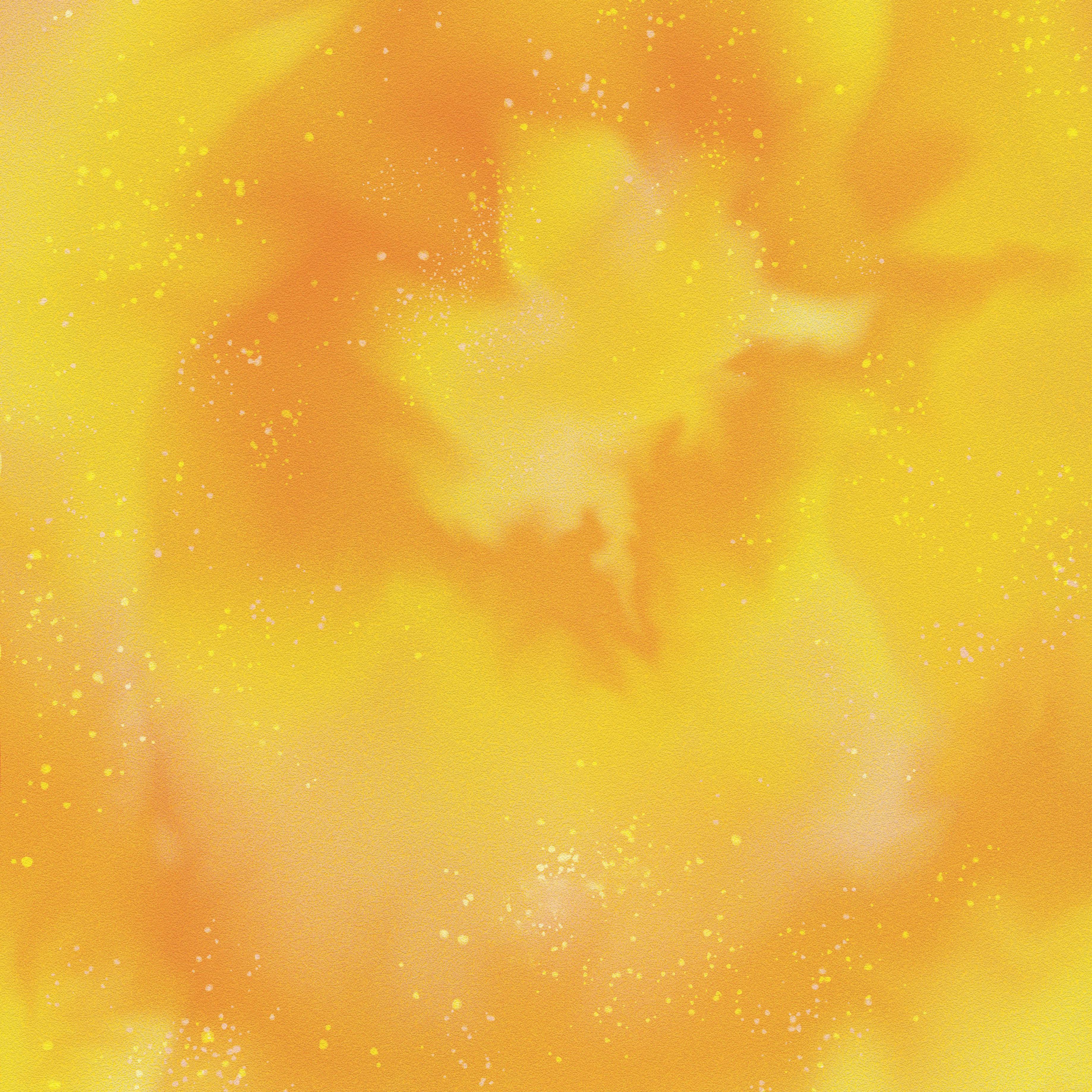 Un motif jaune abstrait avec des taches lumineuses floues et des particules scintillantes qui évoquent un univers lumineux.