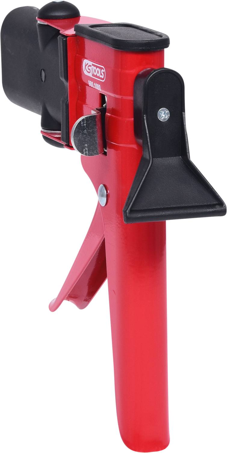 Outil rouge avec une poignée et un embout noir en plastique, probablement un outil manuel utilisé pour tenir ou maintenir des objets.