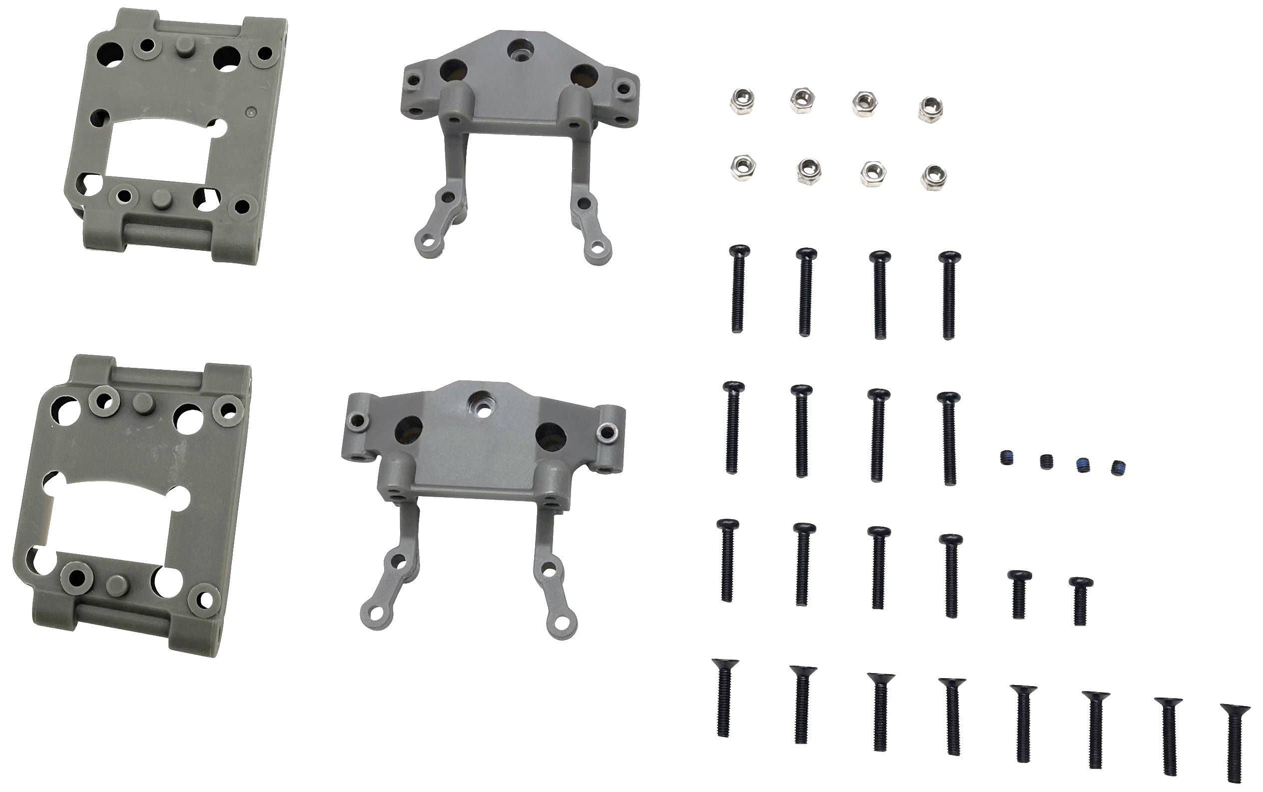 Différentes pièces métalliques et vis, probablement des composants d'un kit de modélisme, disposées sur un fond blanc.