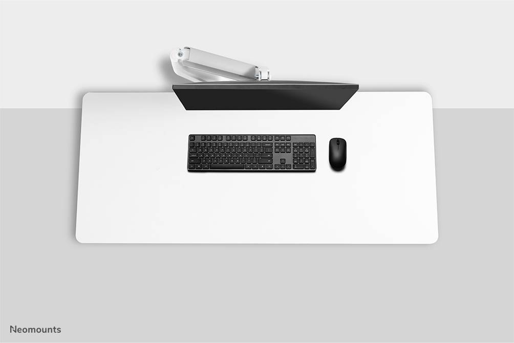 Un bureau blanc avec un clavier et une souris noirs vus d'en haut. Un moniteur noir posé au-dessus du bureau.