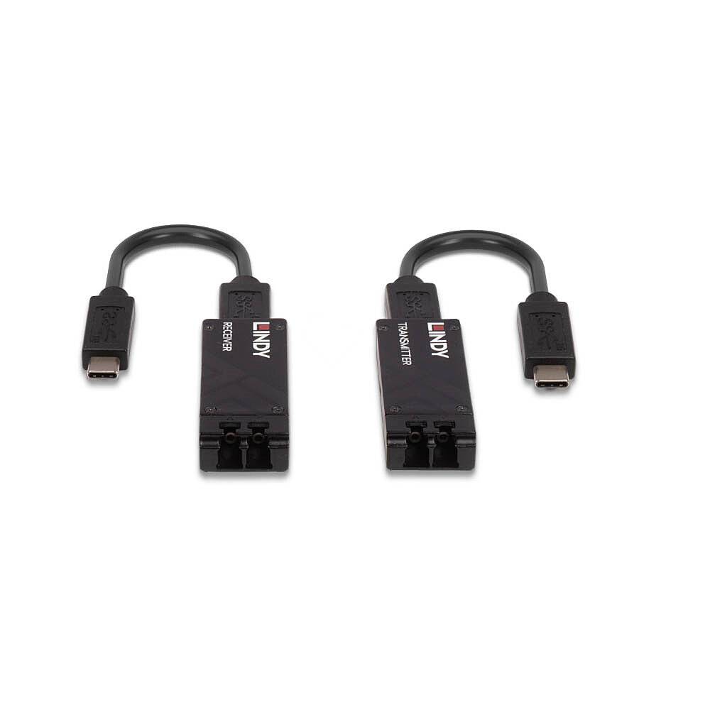 Deux adaptateurs noirs avec connecteurs USB-C et ports optiques. À gauche 'RECEIVER', à droite 'TRANSMITTER', tous deux portant le logo LINDY.