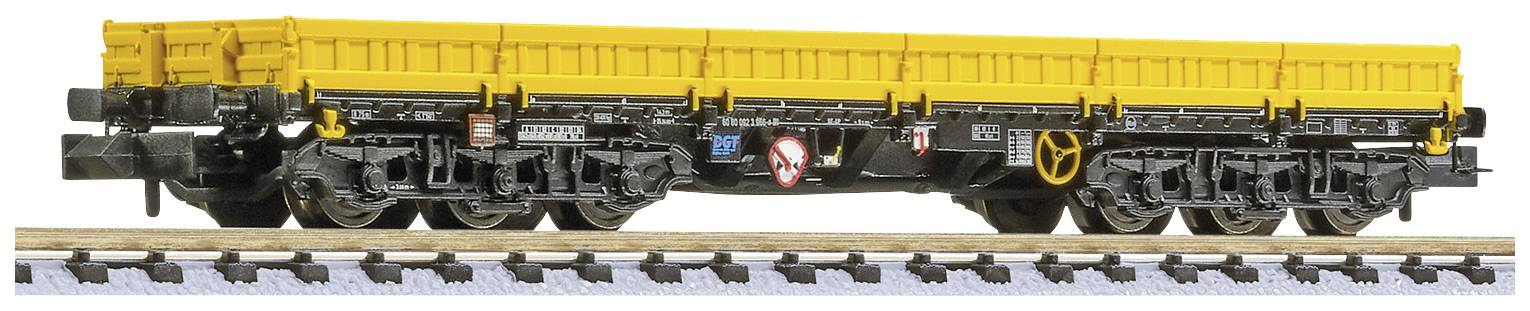 Wagon de marchandises jaune sur des rails, vue latérale, avec des détails noirs et plusieurs essieux, adapté au transport de charges.