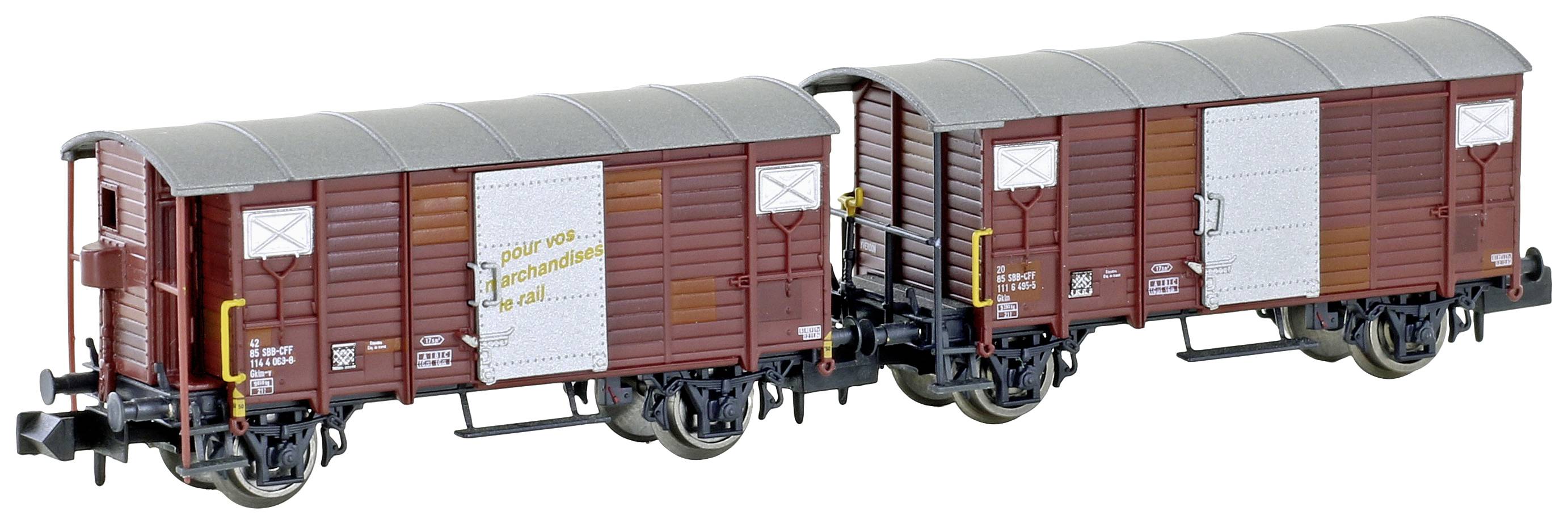 Deux wagons de marchandises bruns avec des toits gris, connectés et posés sur des rails. L'un porte l'inscription 'Fleischmann'.