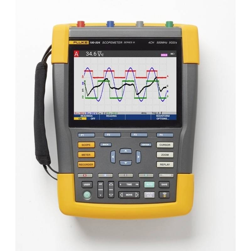Un testeur d'oscilloscope portable affiche un graphique de signal électrique avec plusieurs formes d'ondes et une mesure de 34,6 Vₛ.