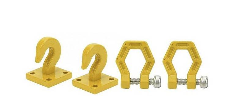 Quatre crochets jaunes, deux en forme de crochet avec une base carrée, deux hexagonaux avec un mécanisme à vis, sur un fond blanc.