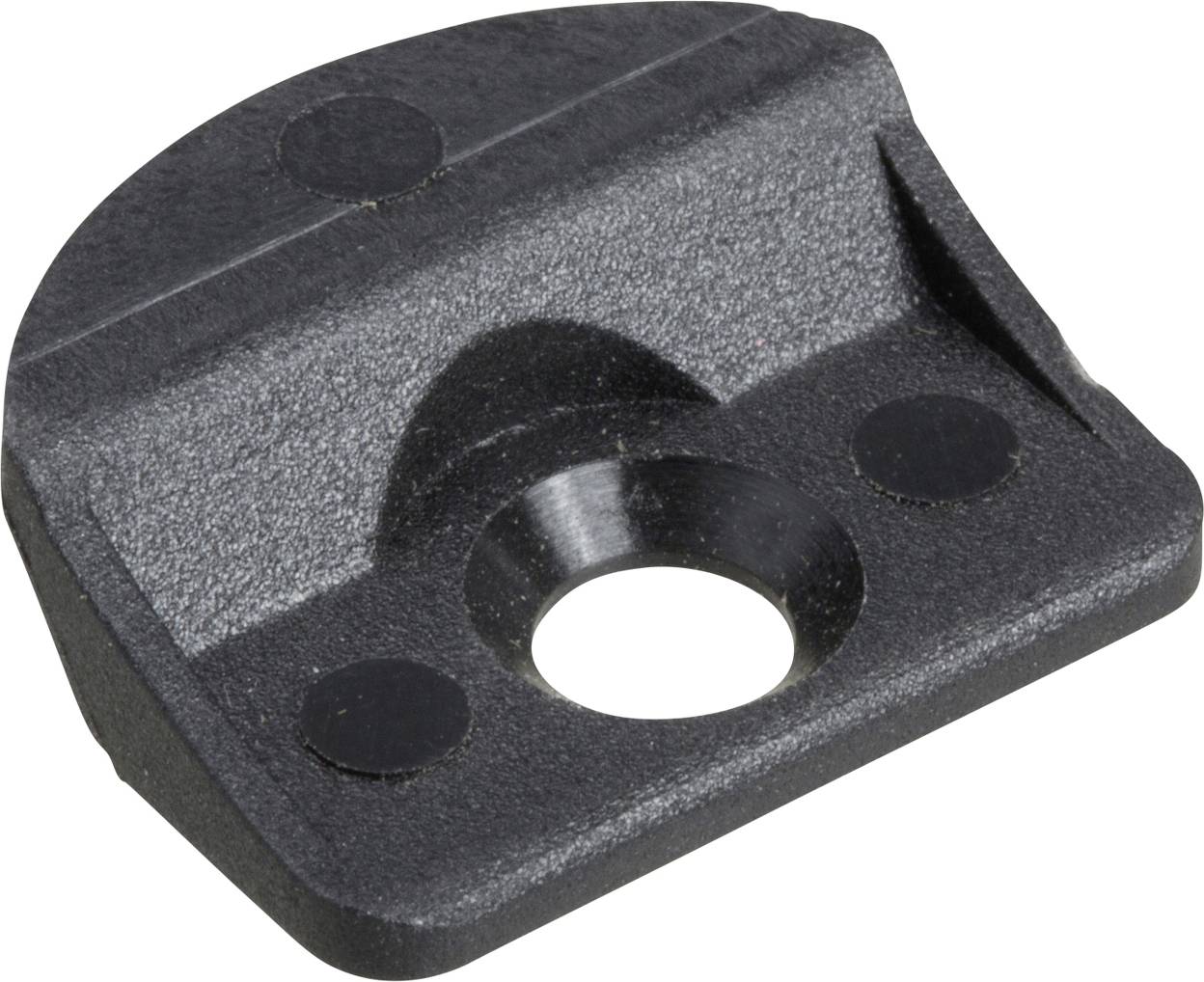 Un objet en plastique noir, rectangulaire, doté d'une ouverture centrale ronde et de plusieurs arêtes courbes, probablement un composant mécanique.