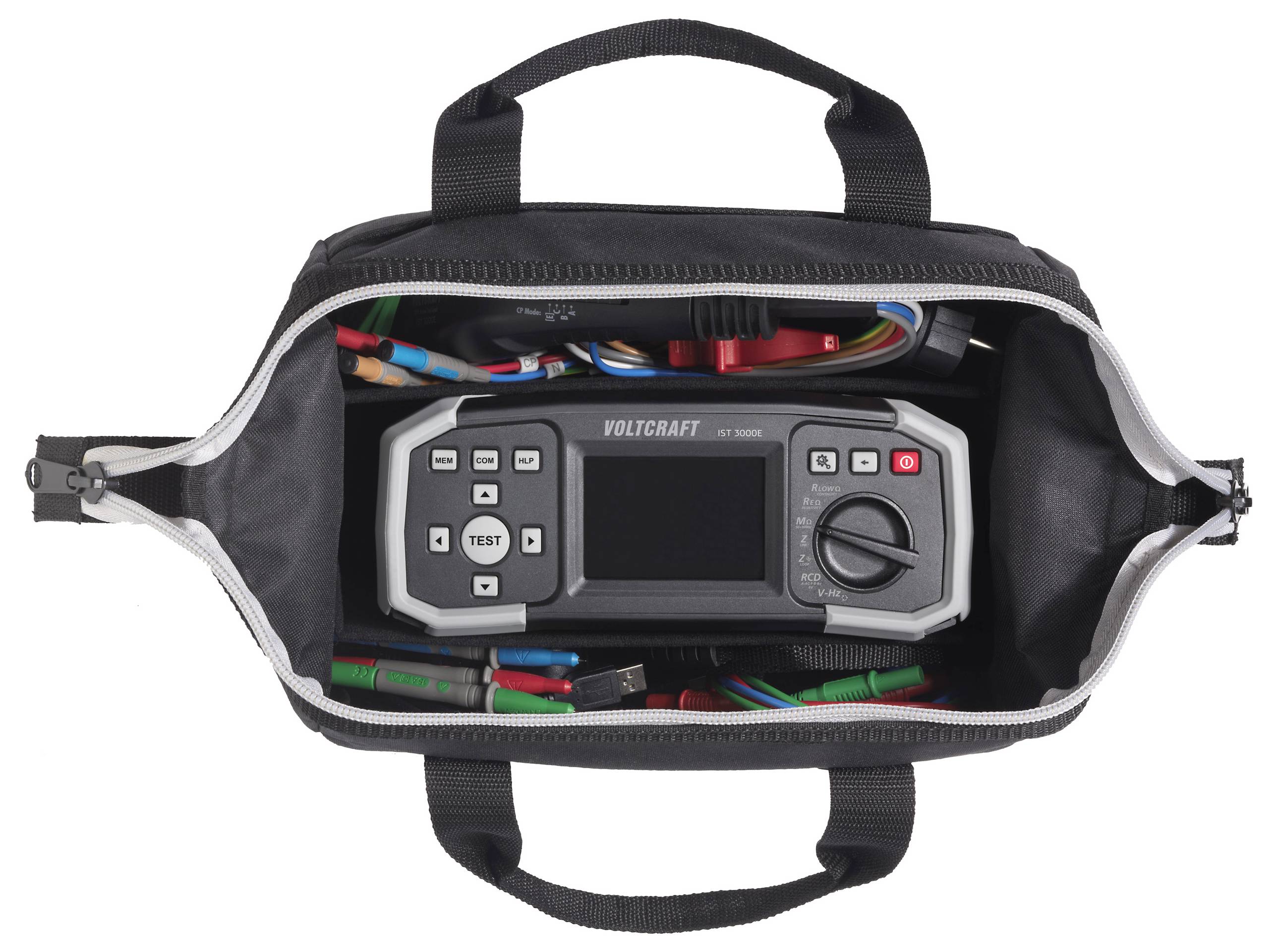 Un sac à outils noir avec une fermeture à glissière ouverte révèle un multimètre numérique étiqueté « Voltcraft ET-1000 » entouré de divers câbles colorés.