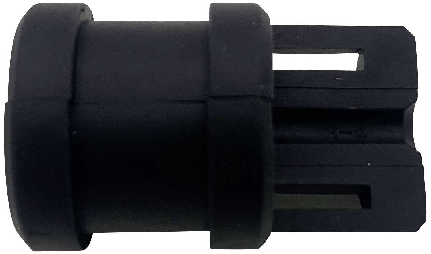 Une pièce en plastique noir de forme cylindrique avec des angles droits. À gauche, une surface solide, à droite, des fentes étroites.