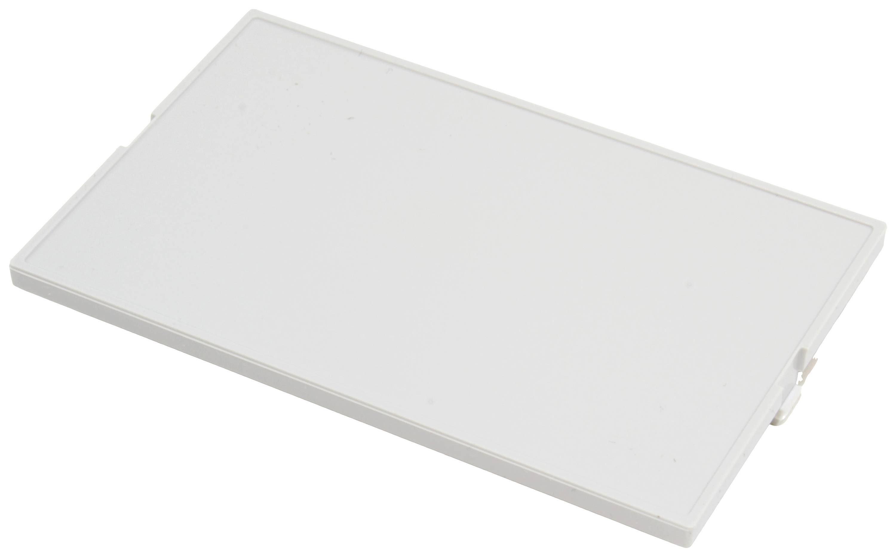 Couvercle en plastique blanc rectangulaire à surface lisse, posé à plat sur une surface.