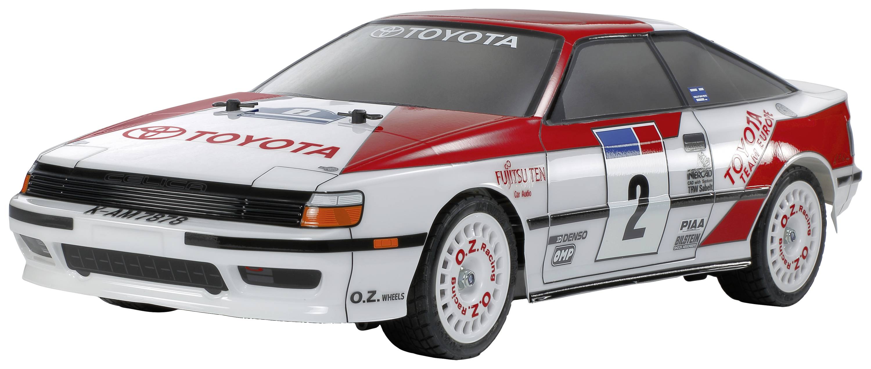 Voiture miniature de style rallye avec des marquages Toyota, peinture rouge et blanche et le numéro de course 2 sur la portière.