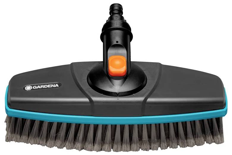 Une brosse de nettoyage noire avec une bordure bleue et un bouton orange, conçue pour une utilisation dans le jardin, présentant des poils sur le côté inférieur.
