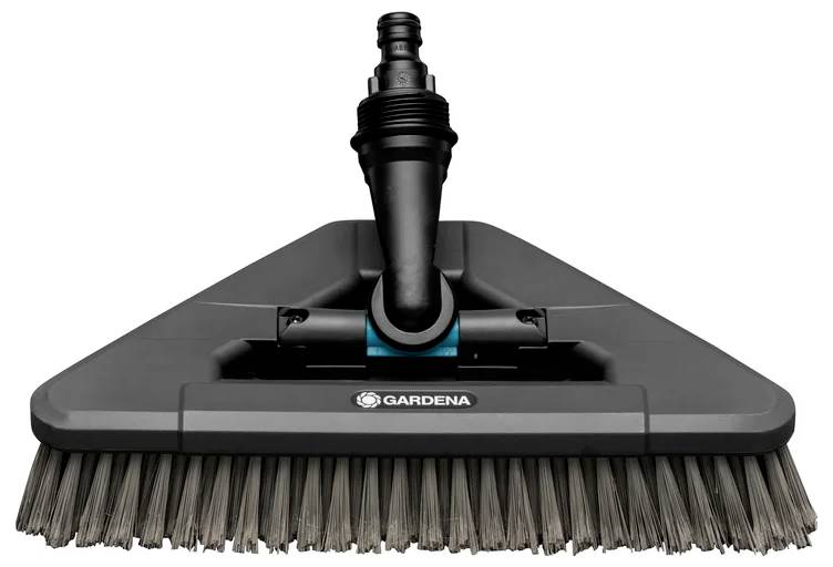 Une brosse de nettoyage triangulaire Gardena avec des poils gris, adaptée au nettoyage des surfaces extérieures dans le jardin.