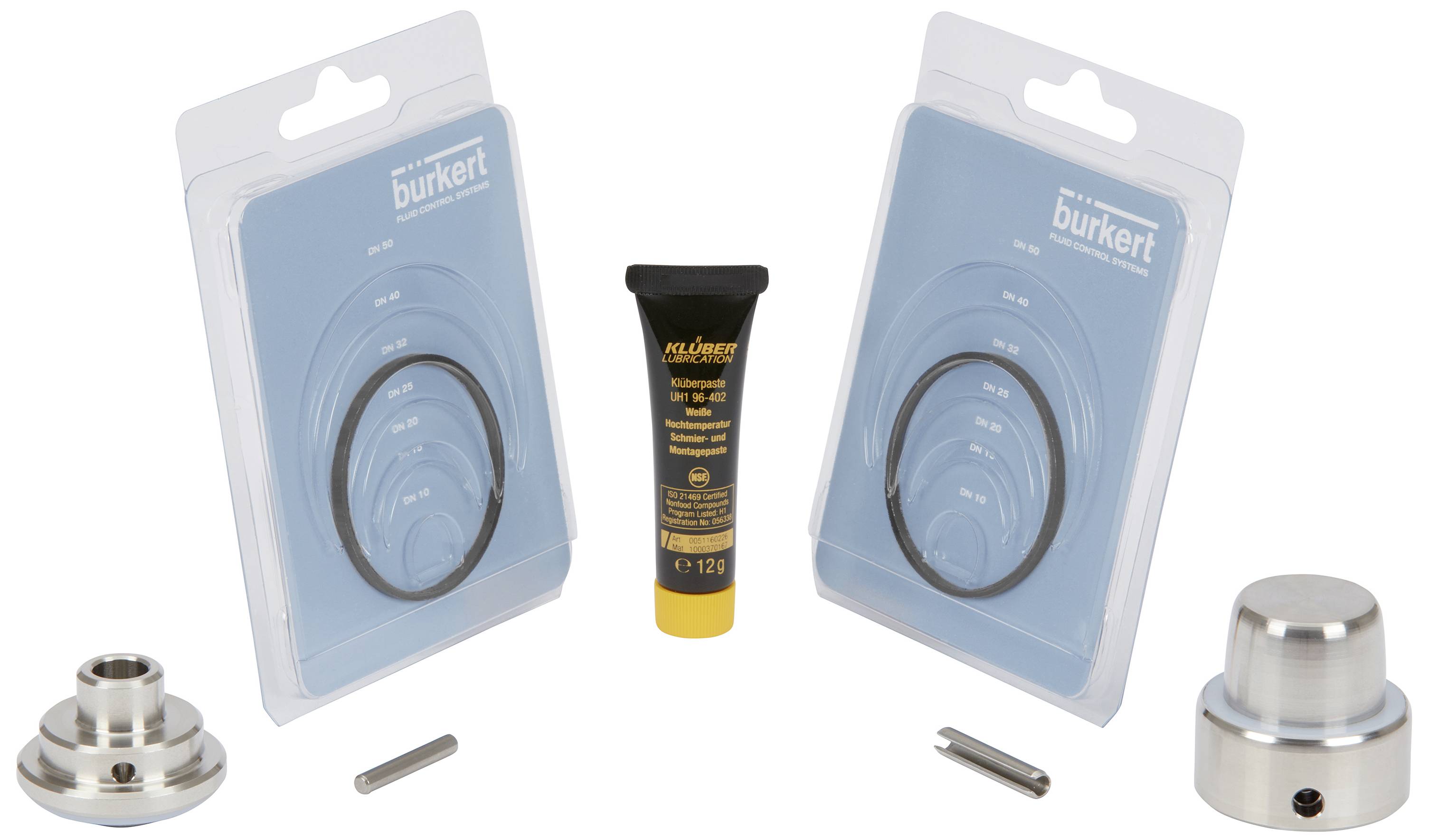 'Kit pour l'entretien d'une valve avec deux joints d'étanchéité dans des emballages, des pièces métalliques et un tuyau de lubrifiant au centre.'