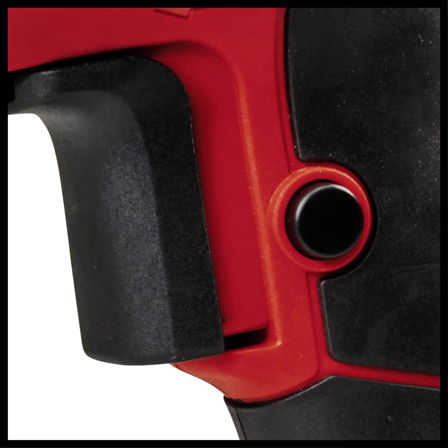 Gros plan d'un outil électrique rouge avec une poignée noire et un bouton rouge.
