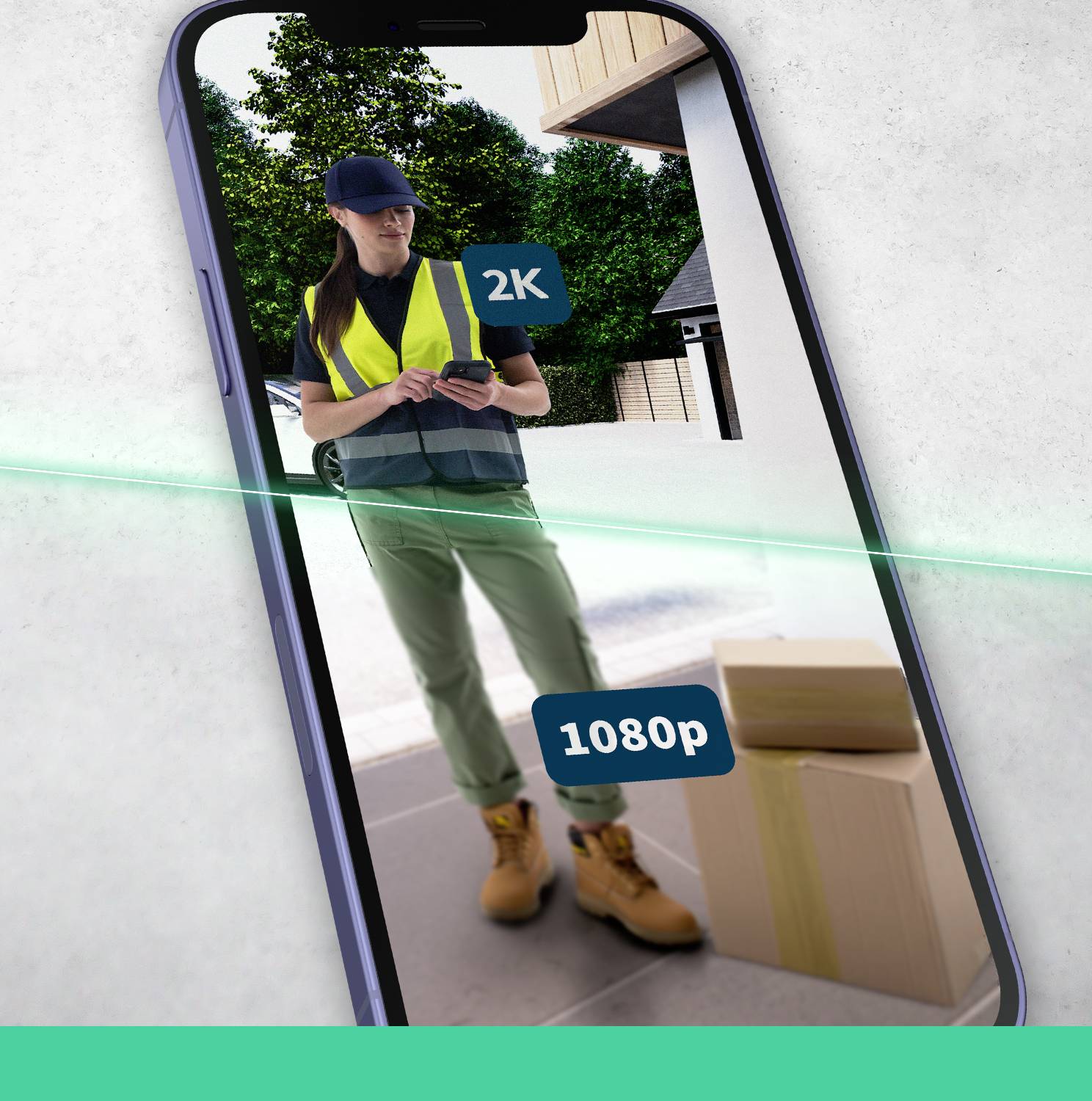 Une personne en tenue de travail se tient sur un écran de smartphone à côté d'un colis. L'écran affiche '2K' et '1080p'.