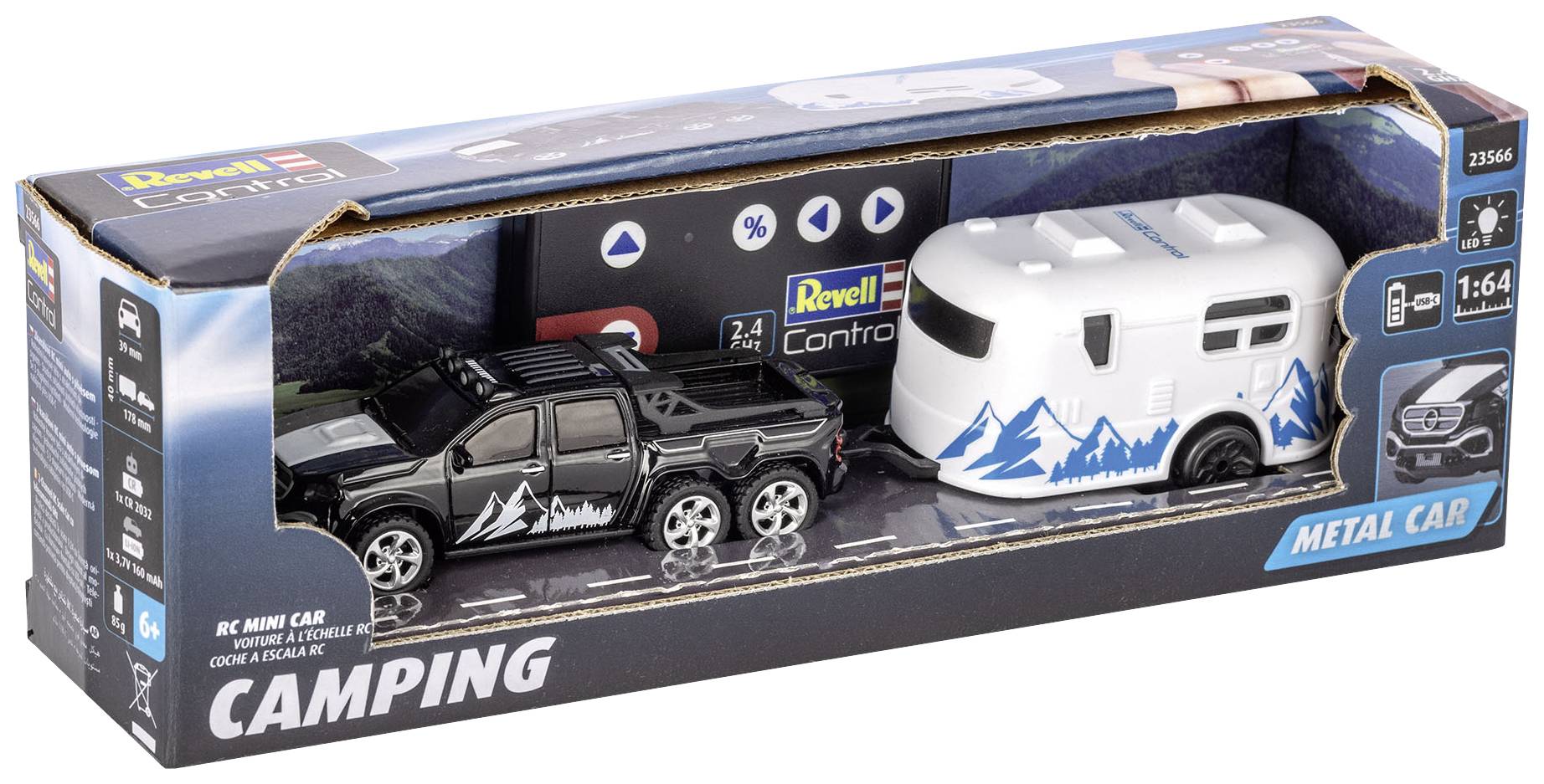 Emballage contenant un pick-up jouet noir et une caravane blanche avec des motifs de montagnes bleues. Le nom de marque 'Revell' est visible.