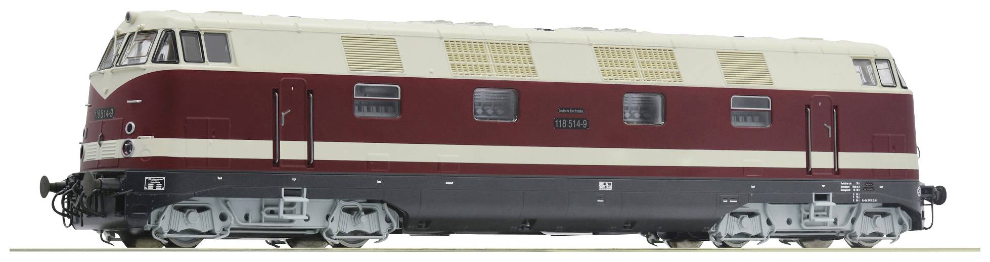 Une locomotive à l'échelle réduite de couleur rouge et crème, vue de profil. Elle présente de grandes fenêtres et des détails réalistes.