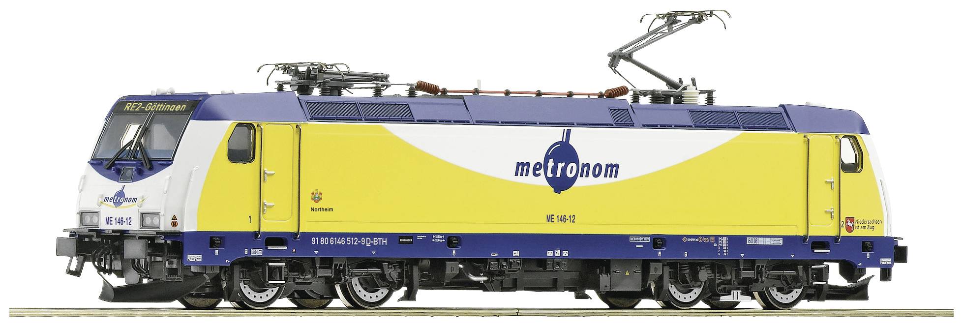 Un train modèle de la marque Metronom avec une peinture jaune et bleue. Il montre des détails tels que les pantographes et les caractéristiques du châssis.