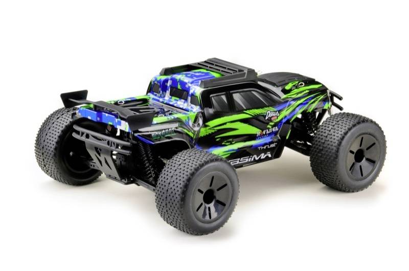Un monster truck télécommandé aux couleurs vives, avec de grandes roues et un design voyant, est posé sur une surface.