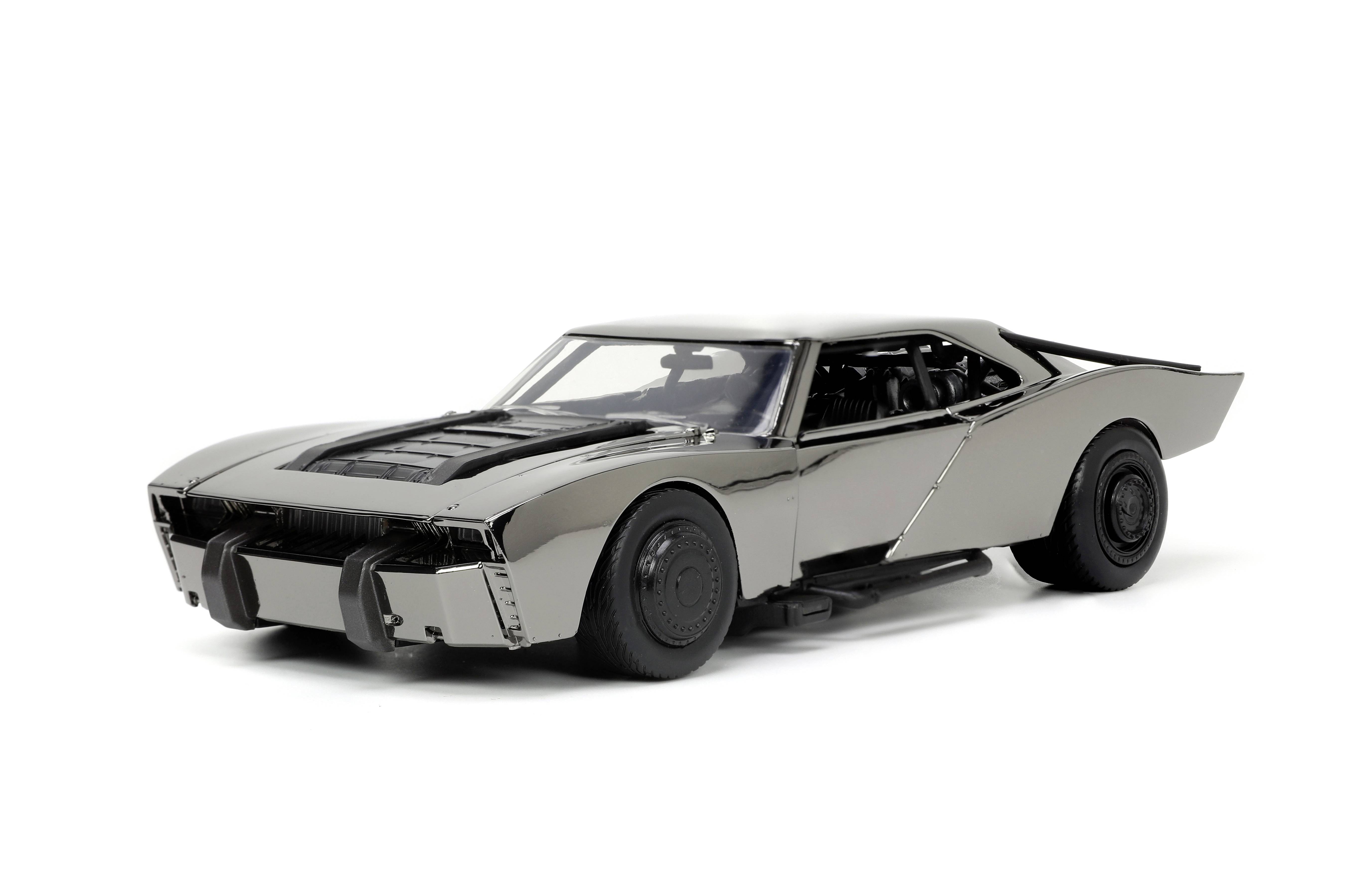 Une voiture miniature gris foncé au design futuriste, avec des jantes noires et une ligne aérodynamique, sur un fond blanc.