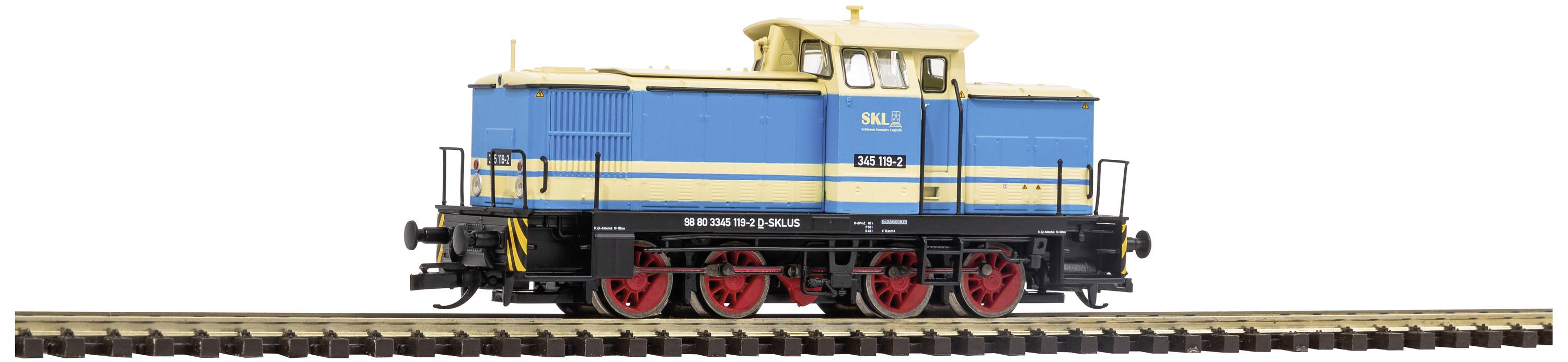 Un modèle bleu et jaune d'une locomotive de train de marchandises avec quatre roues rouges est posé sur un tronçon de rail.