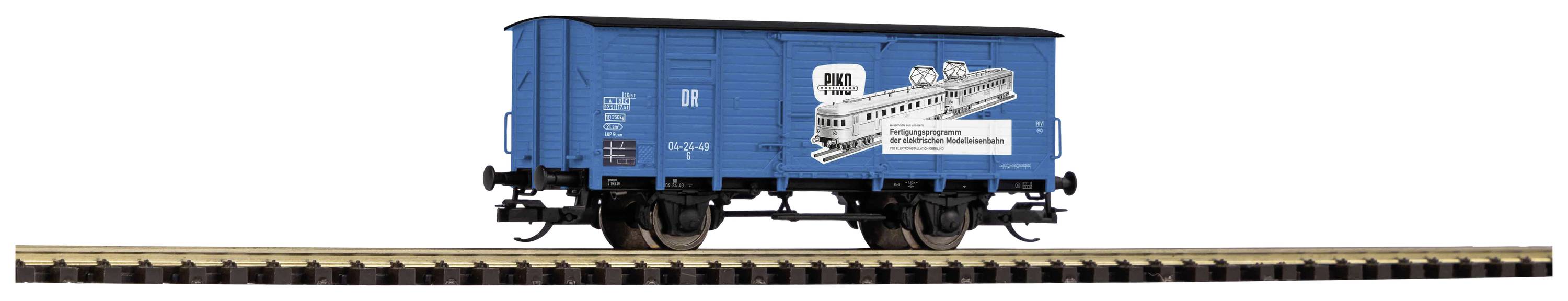 Wagon de train de modèle bleu sur des rails, avec une publicité en noir et blanc pour le train Rheingold, un train historique.