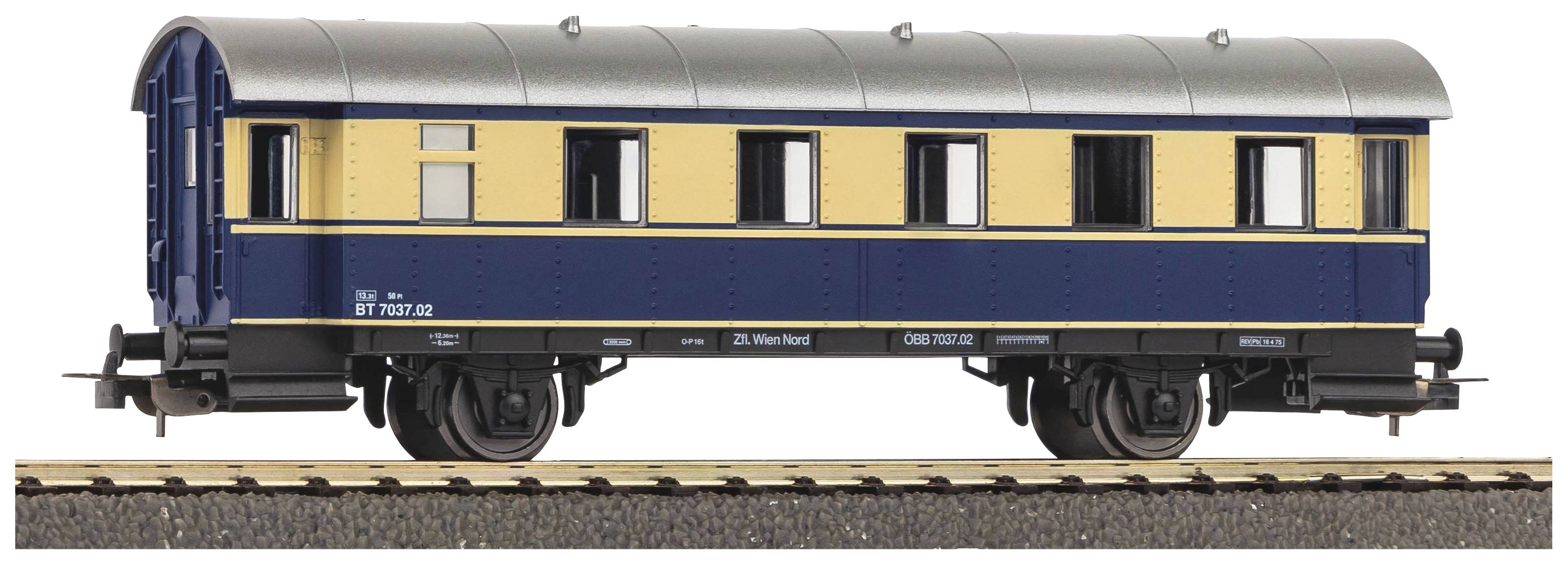 Wagon de train miniature peint en bleu et jaune, placé sur un rail. Le wagon possède plusieurs grandes fenêtres.