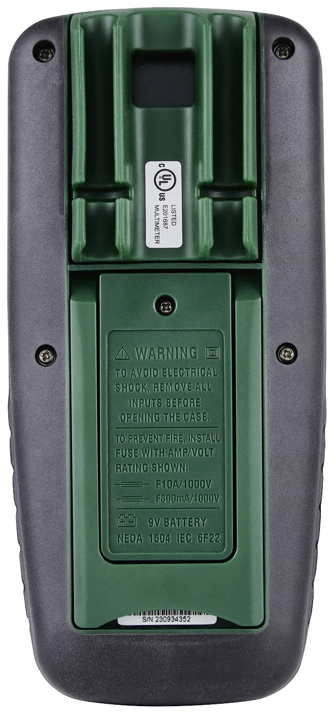 Verso d'un appareil électronique avec couvercle de batterie et avertissements. Trous de vis visibles aux coins.