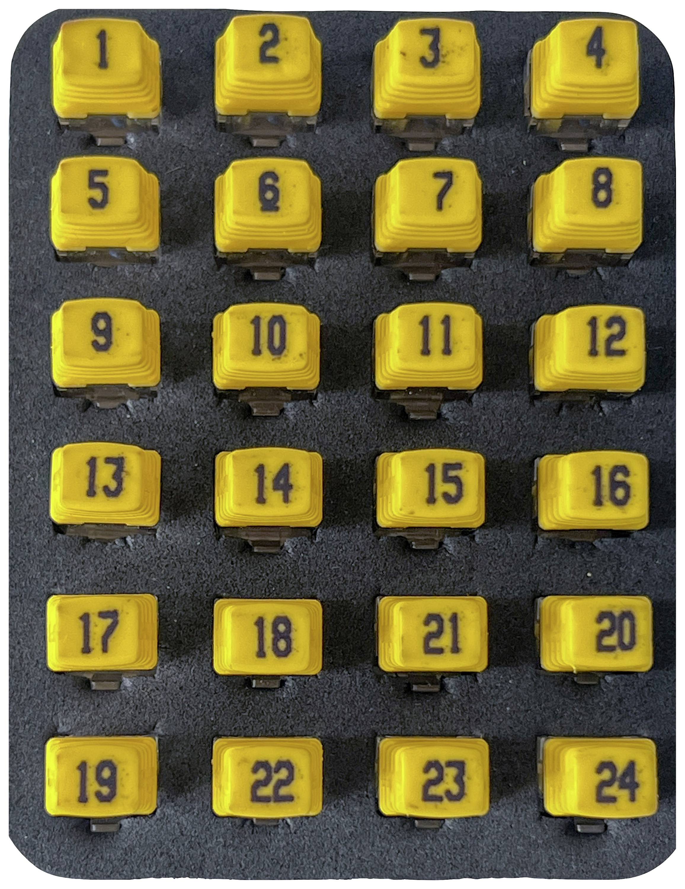 Une boîte contenant 24 touches jaunes numérotées, disposées en quatre rangées de six touches, avec des numéros imprimés de 1 à 24.