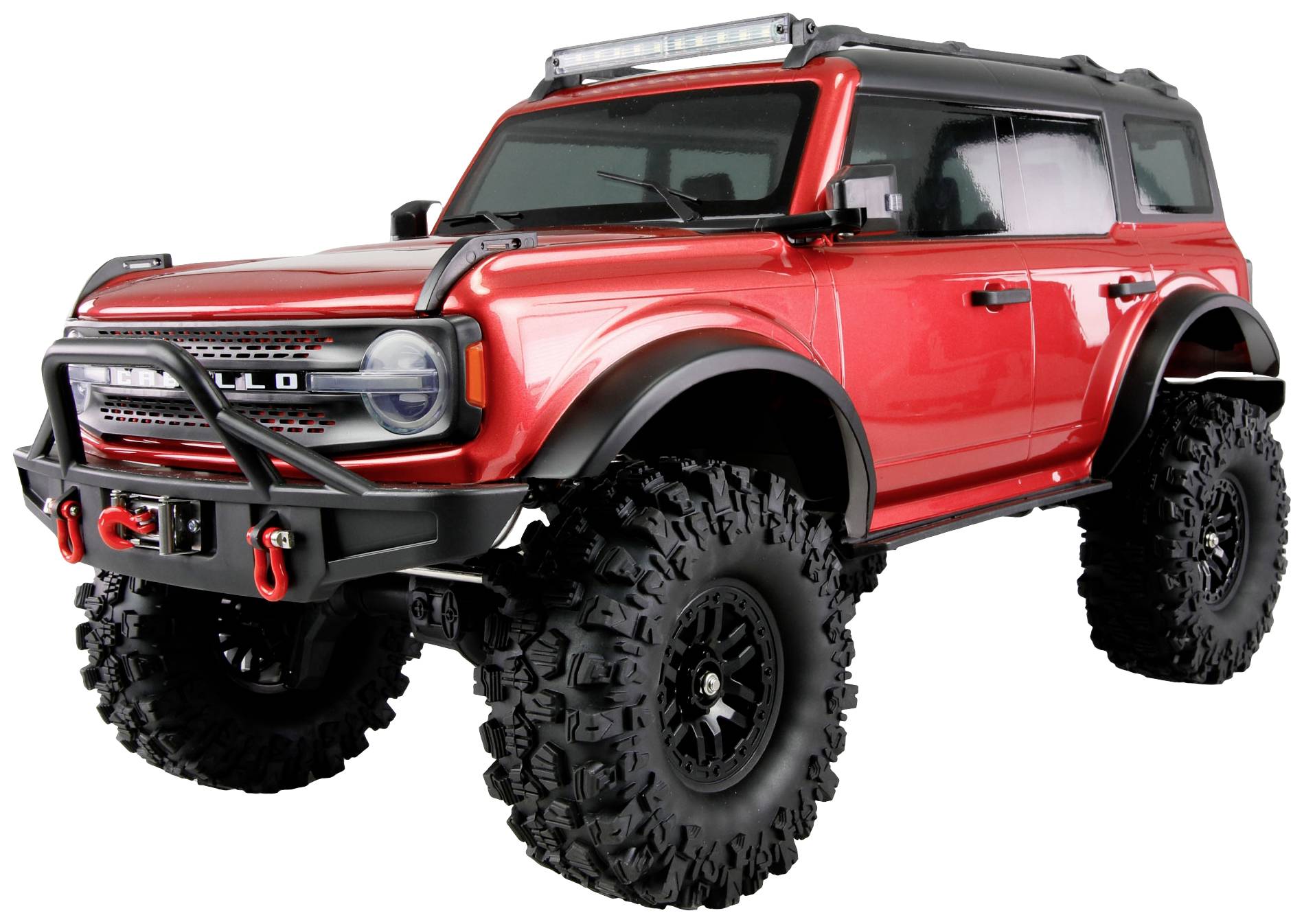 Un tout-terrain rouge avec de grands pneus à profil épais et une barre de toit équipée de phares, représenté dans une position dynamique.