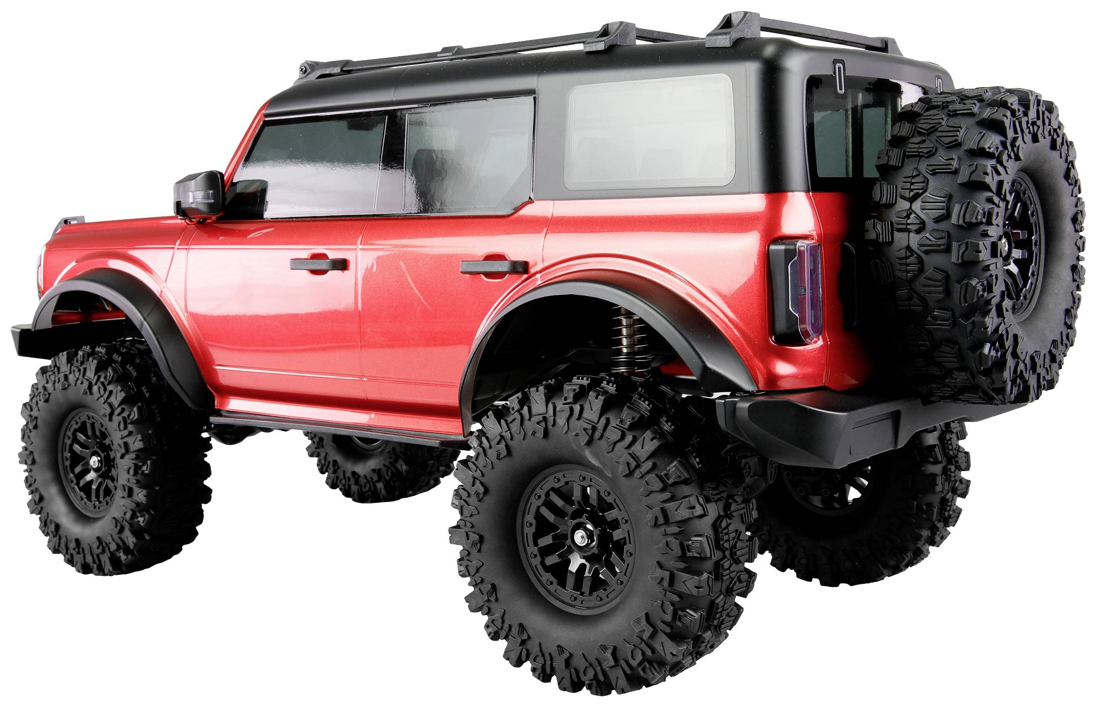 Un modèle de SUV rouge avec de grandes roues, un design robuste et une roue de secours à l'arrière.