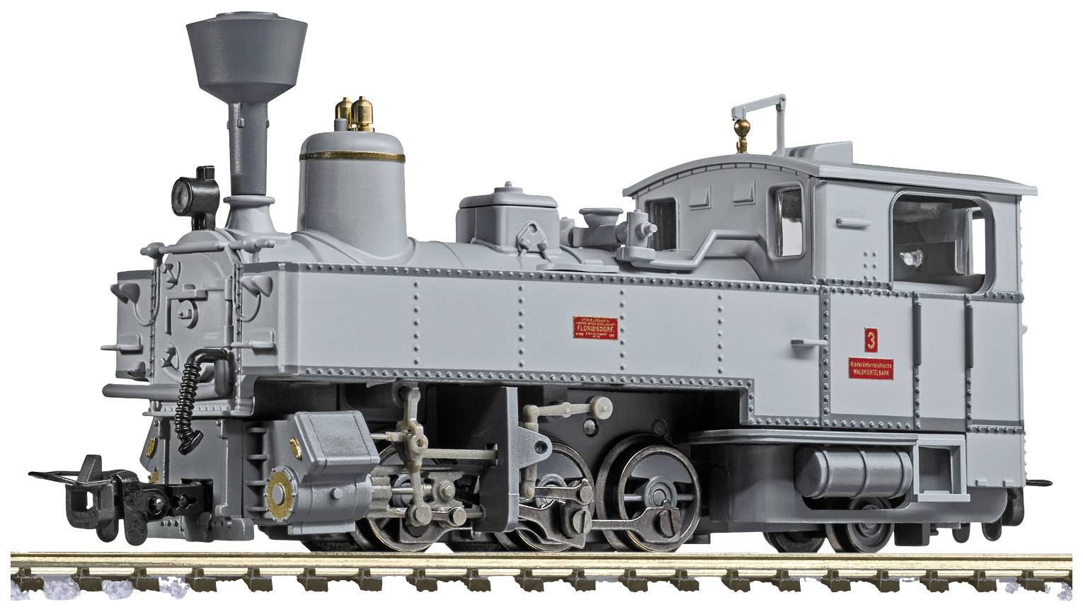 Un modèle gris d'une locomotive à vapeur historique sur des rails, détaillé avec des roues visibles et une cheminée.