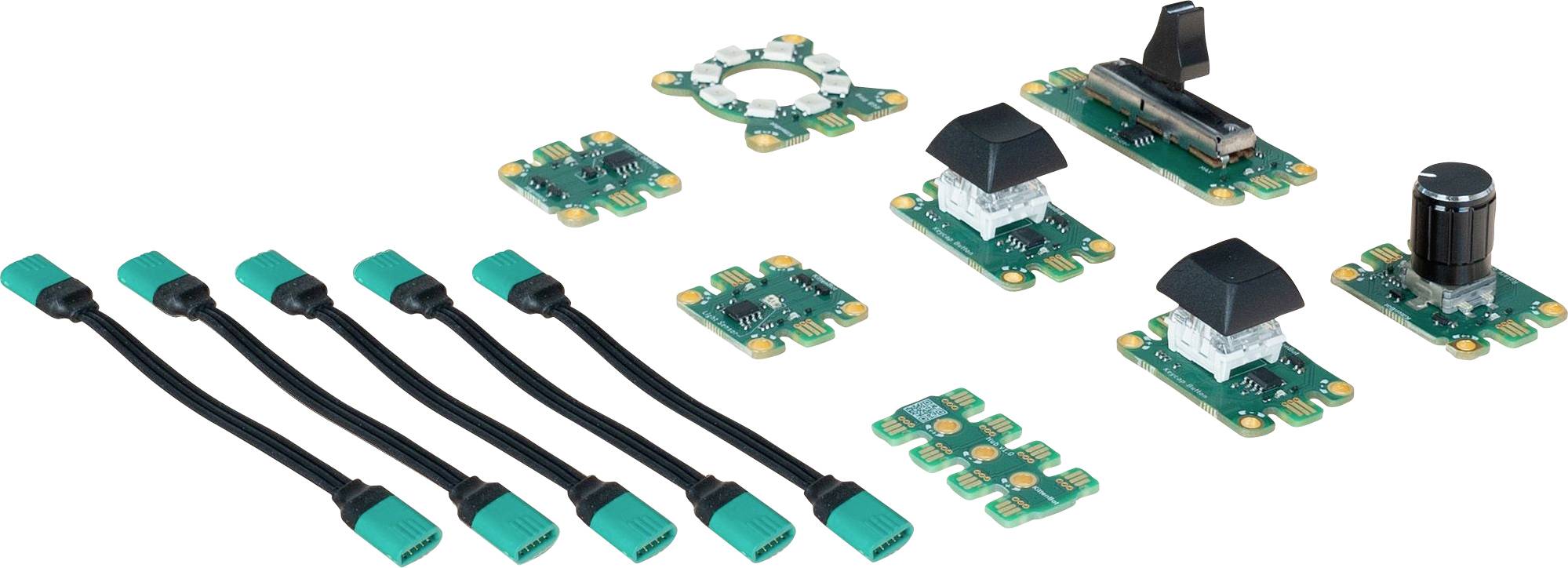 Divers modules électroniques verts et câbles, disposés sur une surface. Comprend des modules d'interrupteurs rotatifs et à bascule.